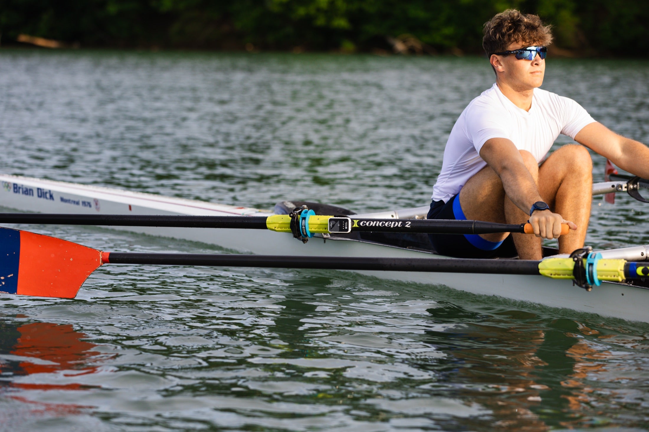 Sculler on the water with a BladeWork sensor mounted on the oar shaft